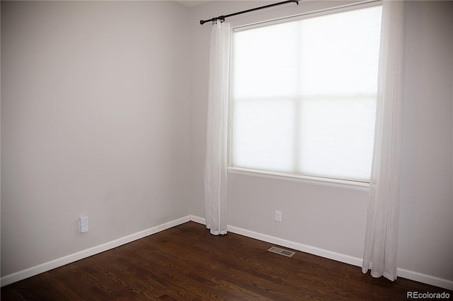 empty room featuring dark hardwood / wood-style flooring