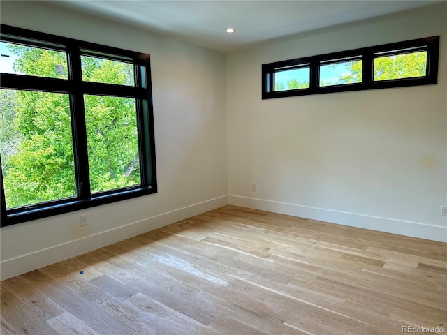 2442 S Saint Paul St, Denver, CO 80210 - empty room with light wood-type flooring and recessed lighting