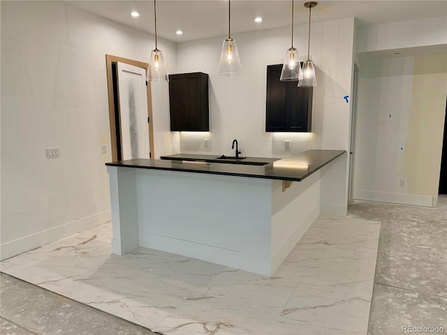 2442 S Saint Paul St, Denver, CO 80210 - kitchen with dark countertops, recessed lighting, light marble finish flooring, and decorative light fixtures