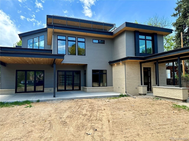 2442 S Saint Paul St, Denver, CO 80210 - back of house featuring a patio area and brick siding