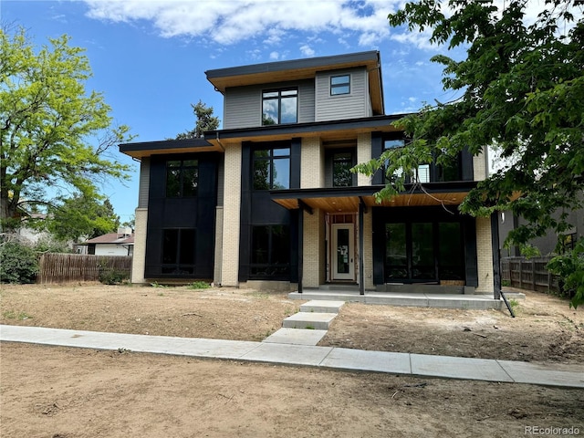 2442 S Saint Paul St, Denver, CO 80210 - contemporary house featuring brick siding and a porch