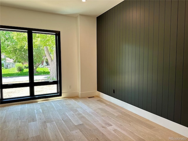 2442 S Saint Paul St, Denver, CO 80210 - empty room with light wood-style flooring and wood walls