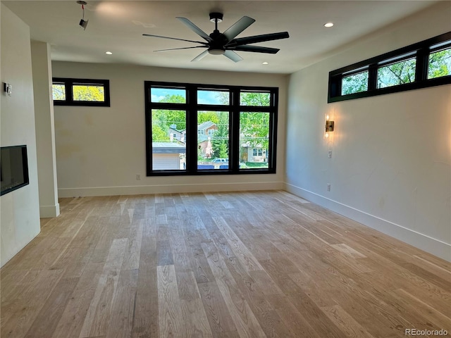 2442 S Saint Paul St, Denver, CO 80210 - unfurnished living room featuring a ceiling fan, light wood-style floors, plenty of natural light, and recessed lighting