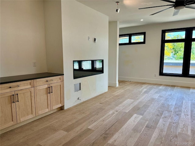 2442 S Saint Paul St, Denver, CO 80210 - unfurnished living room with light wood-style flooring and a ceiling fan