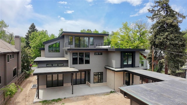 2442 S Saint Paul St, Denver, CO 80210 - back of property with a balcony and a patio area
