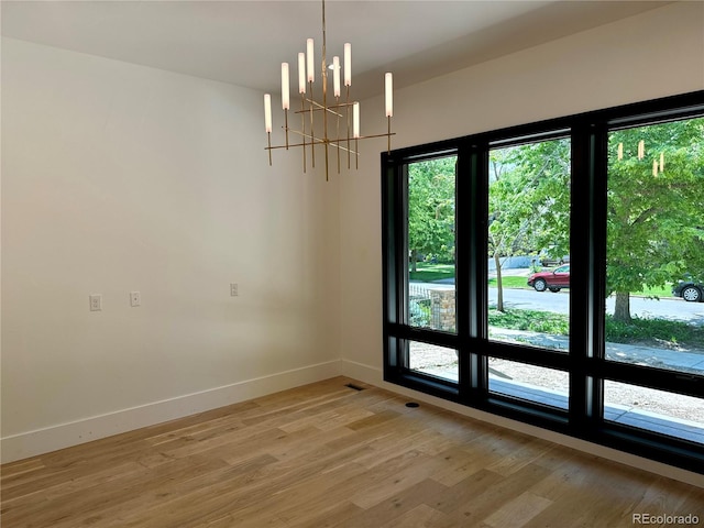 2442 S Saint Paul St, Denver, CO 80210 - unfurnished dining area with light wood-style floors and a chandelier