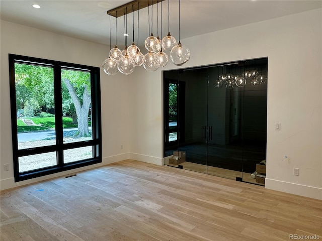2442 S Saint Paul St, Denver, CO 80210 - unfurnished dining area featuring a chandelier, wood finished floors, and recessed lighting