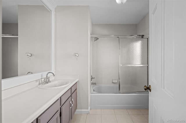 bathroom with combined bath / shower with glass door, tile patterned floors, and vanity