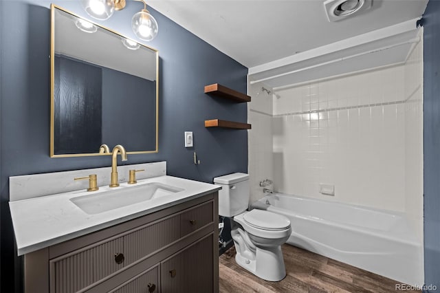 full bath with wood finished floors, toilet, vanity, and bathing tub / shower combination