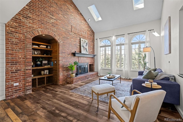 living room featuring a skylight, a fireplace, high vaulted ceiling, and wood-type flooring