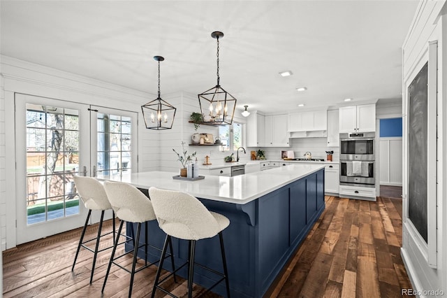 kitchen featuring white cabinets, a sink, a notable chandelier, open shelves, and light countertops