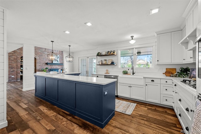 kitchen featuring white cabinetry, open shelves, a sink, and dark wood-type flooring