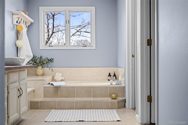 full bath featuring a bath and tile patterned flooring