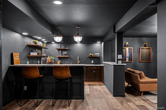 bar with indoor wet bar, pendant lighting, recessed lighting, and light wood-style flooring