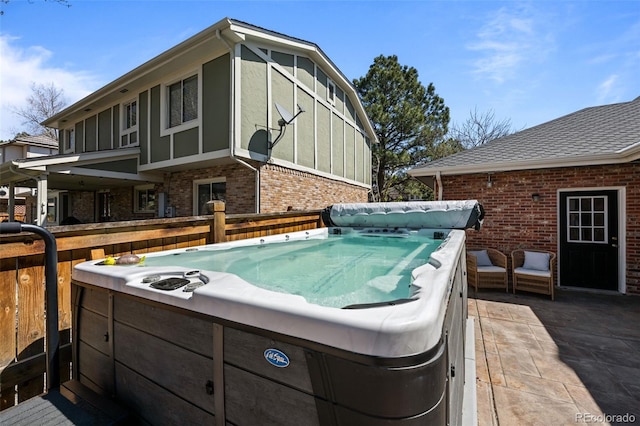 wooden terrace featuring a hot tub