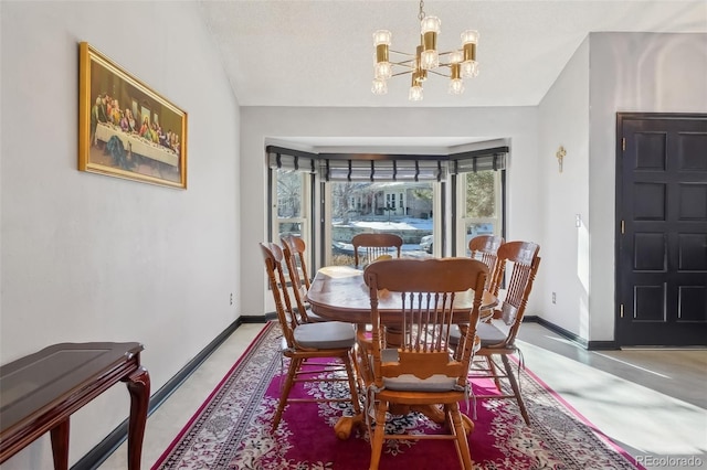 dining room featuring vaulted ceiling and a notable chandelier