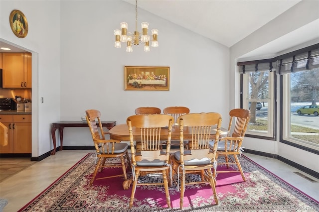 dining area featuring vaulted ceiling and a notable chandelier