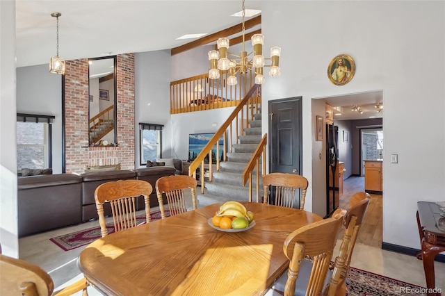 dining area featuring a chandelier and a high ceiling