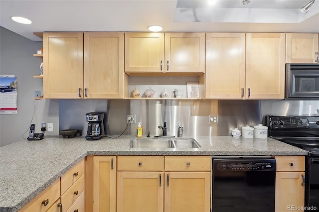 kitchen featuring light brown cabinetry, sink, and black appliances