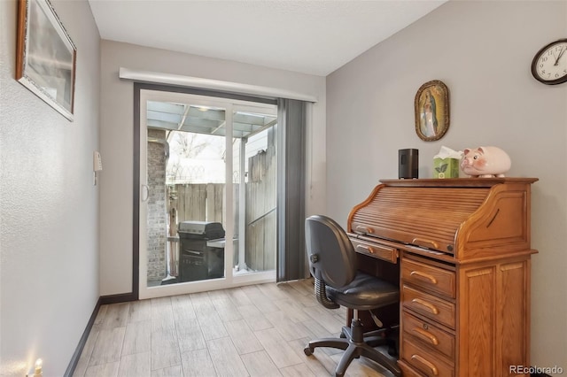 office area with light hardwood / wood-style floors