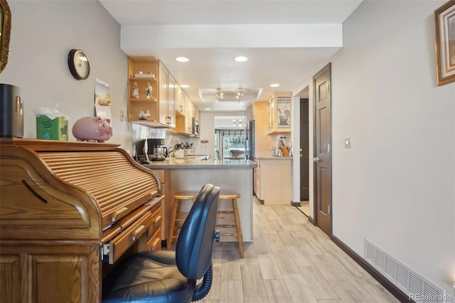 interior space with a kitchen bar and kitchen peninsula