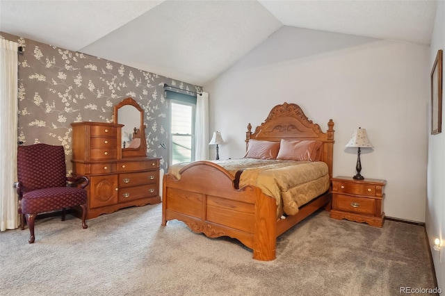 carpeted bedroom with lofted ceiling