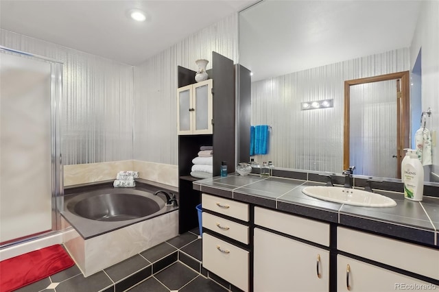 bathroom with shower with separate bathtub, vanity, and tile patterned flooring