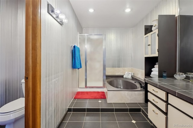 full bathroom featuring toilet, independent shower and bath, tile patterned flooring, and vanity