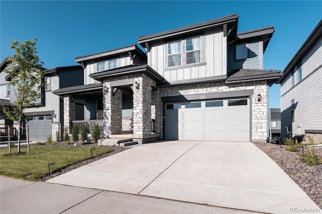2967 S Quaker St, Morrison, CO 80465 - view of front of house featuring a porch, a garage, board and batten siding, stone siding, and driveway