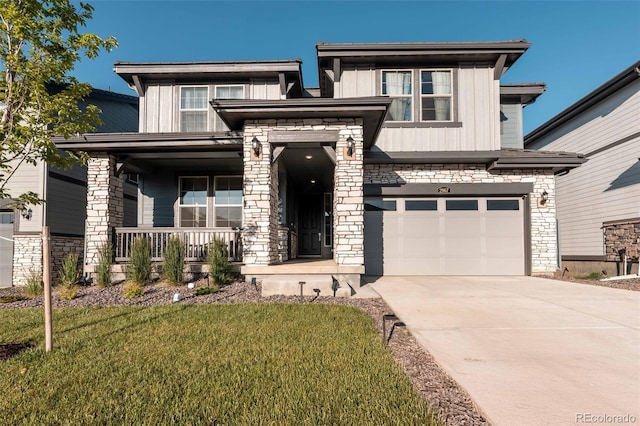 2967 S Quaker St, Morrison, CO 80465 - view of front facade with a garage, stone siding, covered porch, and driveway