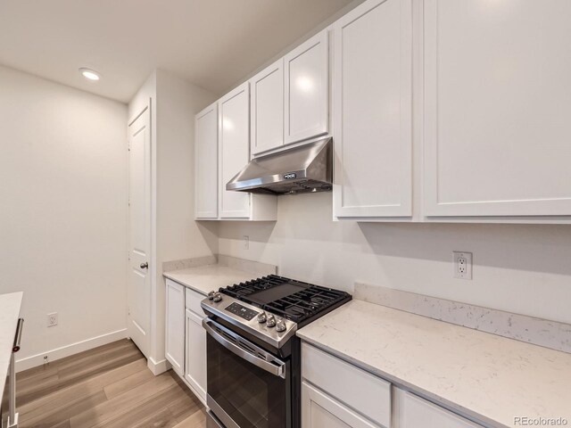 2967 S Quaker St, Morrison, CO 80465 - kitchen featuring under cabinet range hood, stainless steel range with gas stovetop, light wood finished floors, white cabinetry, and recessed lighting