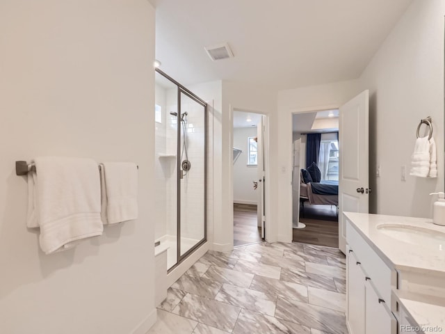 2967 S Quaker St, Morrison, CO 80465 - bathroom featuring a shower stall, vanity, ensuite bath, and marble look tiles