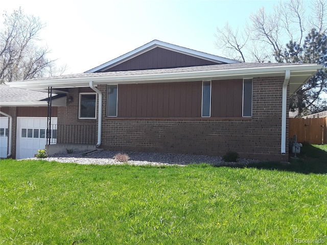 view of side of property with a garage and a lawn