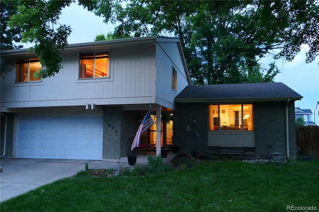1936 S Poplar St, Denver, CO 80224 - view of front facade featuring brick siding, concrete driveway, an attached garage, and covered porch