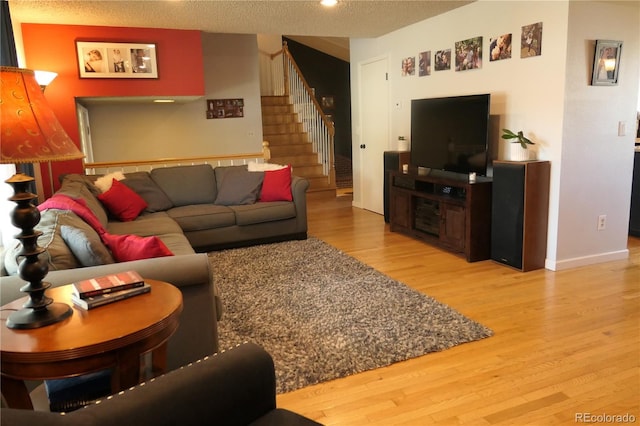 1936 S Poplar St, Denver, CO 80224 - living room featuring wood finished floors, stairs, and a textured ceiling