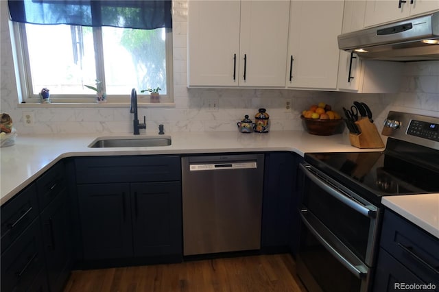 1936 S Poplar St, Denver, CO 80224 - kitchen with appliances with stainless steel finishes, exhaust hood, tasteful backsplash, white cabinets, and light countertops