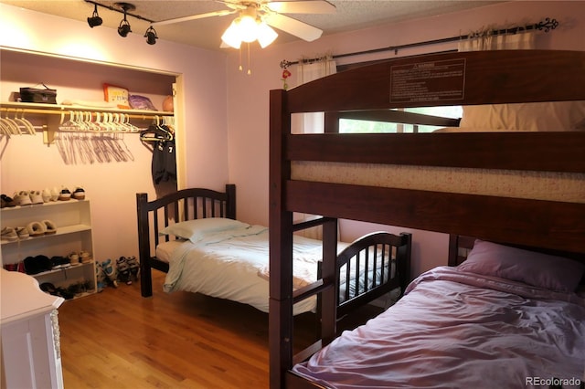 1936 S Poplar St, Denver, CO 80224 - bedroom with wood finished floors, a walk in closet, and a ceiling fan