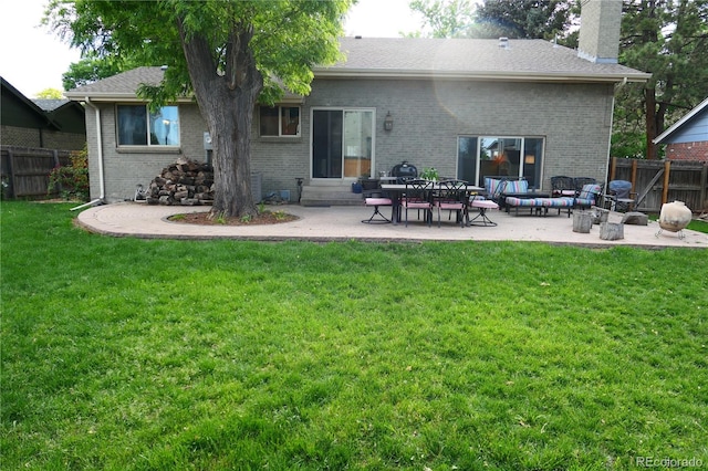 1936 S Poplar St, Denver, CO 80224 - back of house with a patio area, brick siding, and a chimney