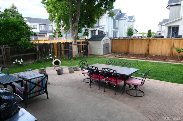 1936 S Poplar St, Denver, CO 80224 - fenced backyard featuring outdoor dining space, a patio area, a storage shed, and a residential view
