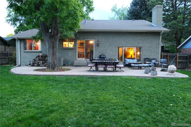 1936 S Poplar St, Denver, CO 80224 - rear view of property featuring a chimney, brick siding, and a patio
