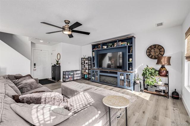 living room with hardwood / wood-style floors and ceiling fan