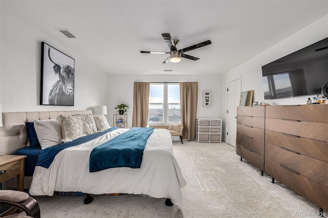 bedroom with ceiling fan and light carpet