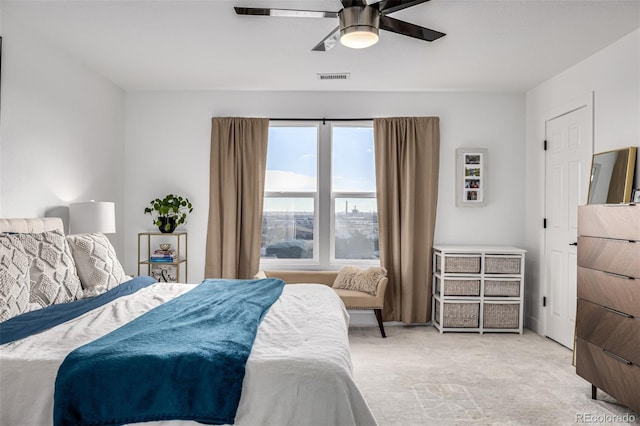 bedroom with ceiling fan and light carpet