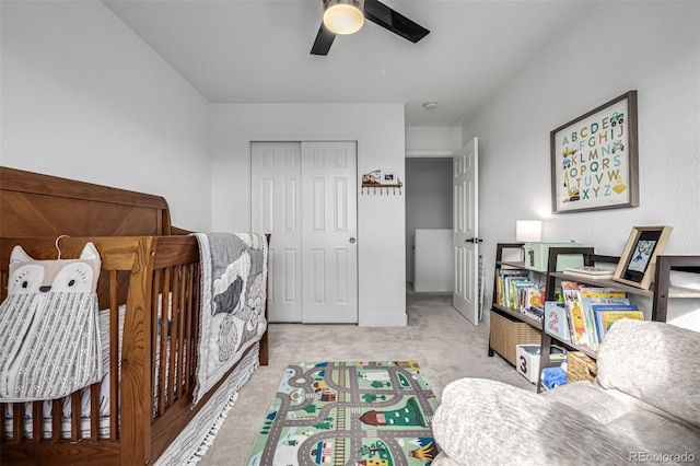 carpeted bedroom with ceiling fan and a closet