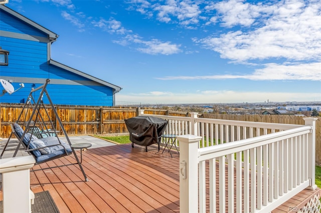 wooden terrace featuring a grill