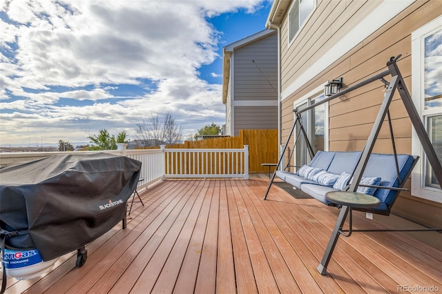 deck featuring outdoor lounge area and grilling area