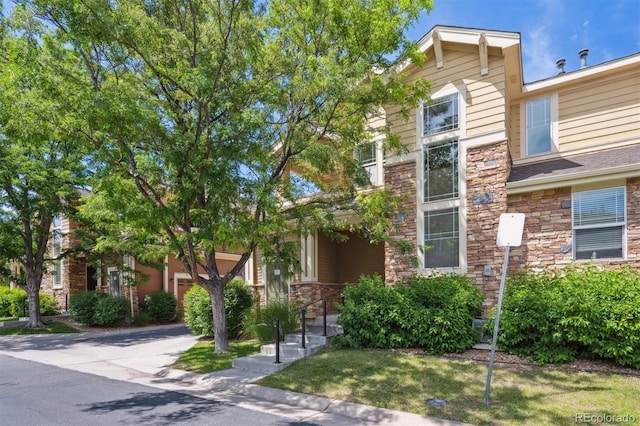 14197 W 84th Cir Unit C, Arvada, CO 80005 - view of front facade featuring stone siding and concrete driveway