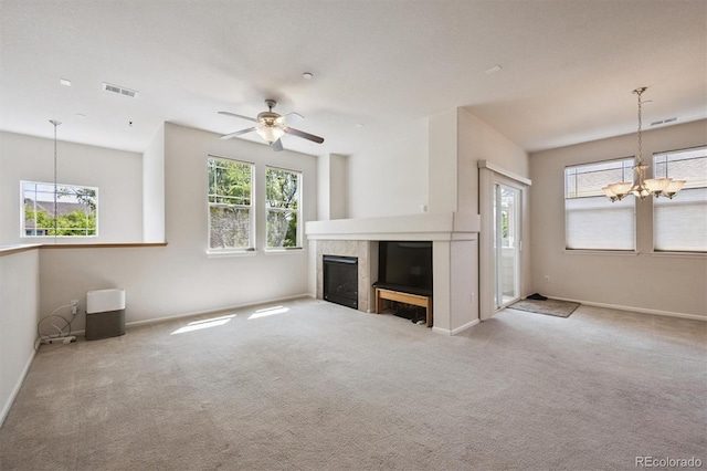14197 W 84th Cir Unit C, Arvada, CO 80005 - unfurnished living room with a chandelier, a fireplace, carpet floors, and a ceiling fan