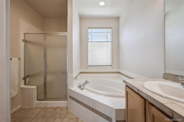 14197 W 84th Cir Unit C, Arvada, CO 80005 - full bath featuring vanity, a stall shower, a garden tub, and tile patterned floors