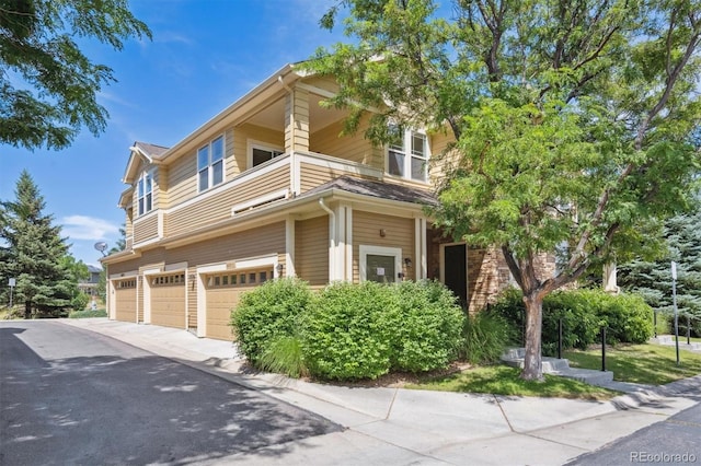 14197 W 84th Cir Unit C, Arvada, CO 80005 - view of front facade with an attached garage and asphalt driveway